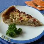 Ein Stück Chicorée-Quiche auf einem Teller